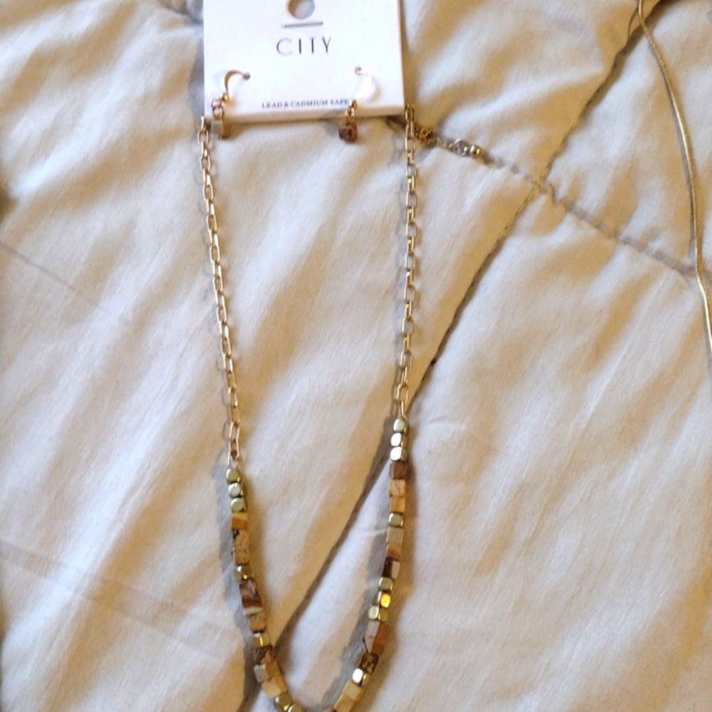 Two sitting necklaces with earrings to go